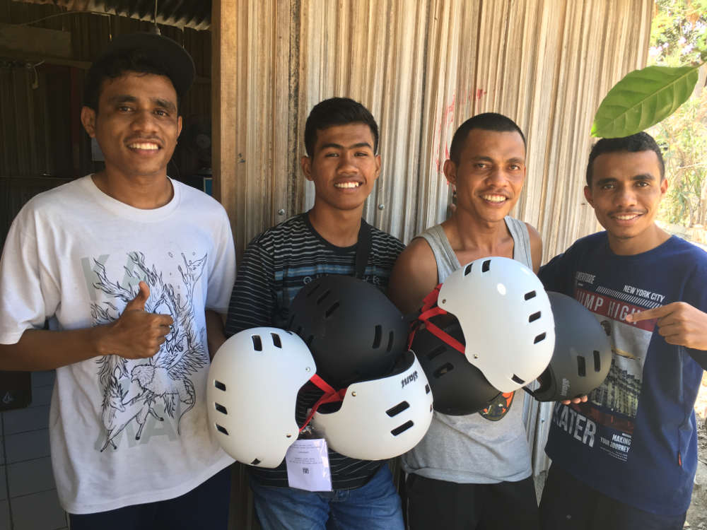 Locals with helmets donated by Globe.